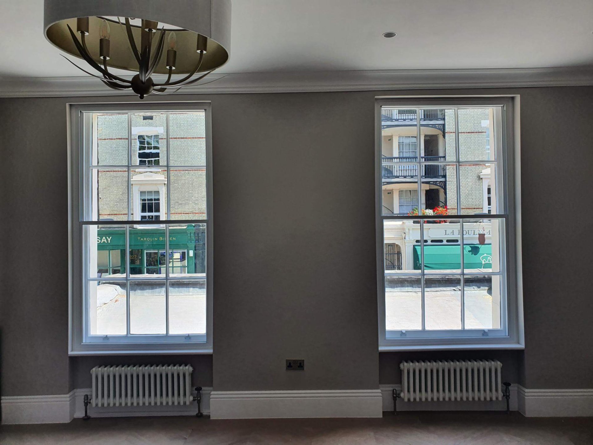 Soundproof secondary glazing fitted to tall Victorian sash windows in an elegant Chelsea living room